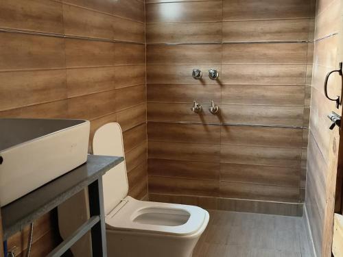 a bathroom with a toilet and a sink at Riverside Glamping By StayApart x Elephant Brook in Bijni