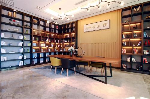 a dining room with a wooden table and chairs at Atour Hotel (Turpan Wenhua West Road) in Turfan