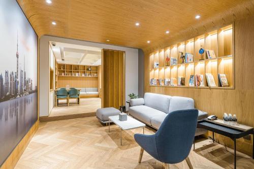 a living room with a couch and a table at Atour Hotel Shanghai Hongqiao International Exhibition Beixinjing in Shanghai