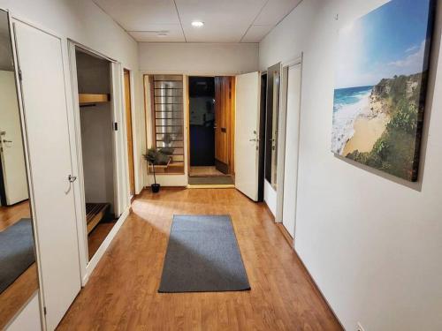 a hallway with a rug on a hard wood floor at Nice and cozy big house for 8 people with sauna in Vantaa