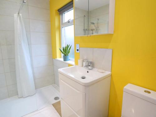 a bathroom with a white sink and a shower at Pass the Keys King Bed House Next To Heaton Park WM Discounts in Manchester