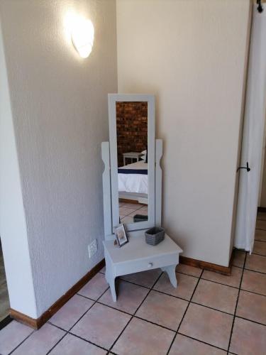 a mirror sitting on a table in a room at Shingalana Guest Lodge in Hazyview