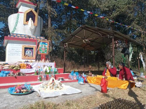a couple of people sitting in front of a market at Unique point home stay in Nagarkot