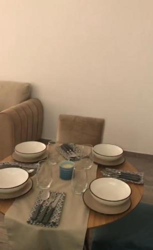 una mesa con platos y copas de vino. en Apartamento ik en marrakech, en Marrakech