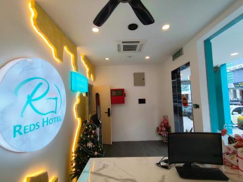 an office with a reed hotel sign on the wall at Red's Hotel in Bintulu