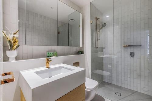 a bathroom with a sink and a shower and a toilet at Elevated Elegance - A Fusion of Style and Comfort in Melbourne