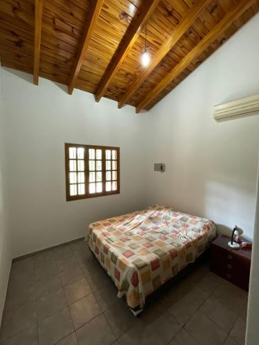 a bedroom with a bed and a wooden ceiling at Casa Frank in Bermejo
