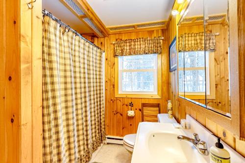 a bathroom with a sink and a toilet at Poplar Stream Chalet in Carrabassett