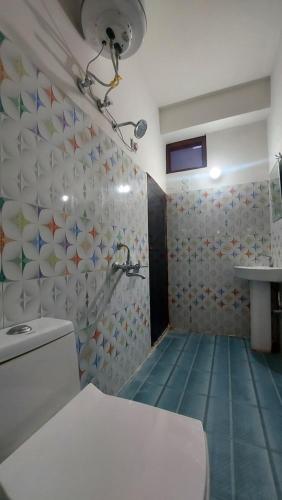 a bathroom with a shower with a toilet and a sink at HILL PARADIZÈ couple friendly in Mussoorie