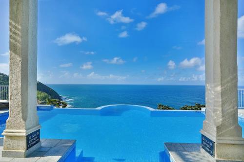 a view of the ocean from a hotel pool at Cayman Villa - Contemporary 4 bedroom Villa with Stunning Ocean Views villa in Cap Estate