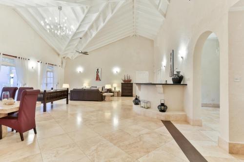 a large living room with a table and chairs at Cayman Villa - Contemporary 4 bedroom Villa with Stunning Ocean Views villa in Cap Estate