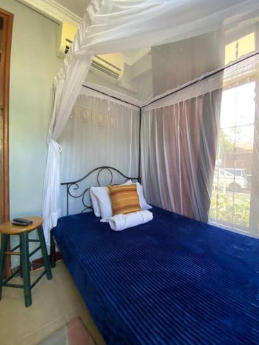 Giường trong phòng chung tại Charming Room, Swimming POOL - Mikocheni Garden Rd