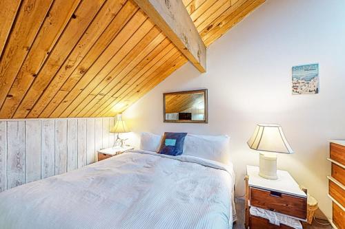 a bedroom with a large bed with wooden ceilings at Wooded Dreams in Whitefish