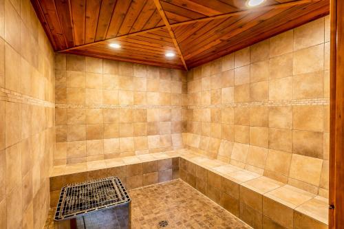 a room with a tub with a wooden ceiling at Wooded Dreams in Whitefish