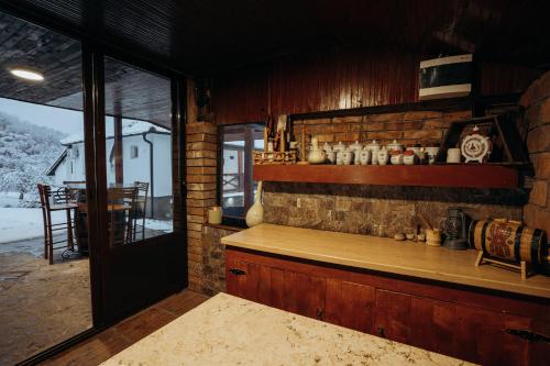 a kitchen with a counter and a brick wall at Casa DaFin Tekija - Kladovo in Tekija
