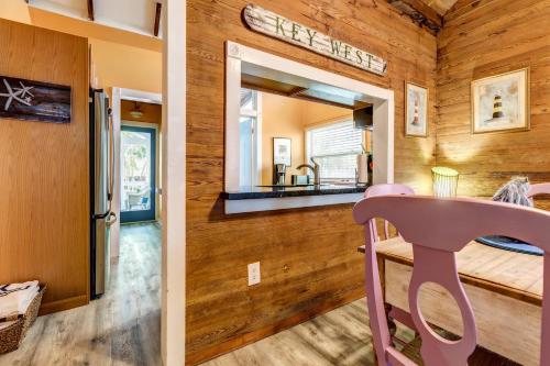 a pink chair in a room with a mirror at Bahama House in Key West