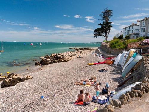 a group of people laying on a rocky beach at Flat 1, Medeira House in Seaview