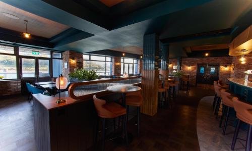 a bar in a restaurant with chairs and tables at Waterford Marina Hotel in Waterford