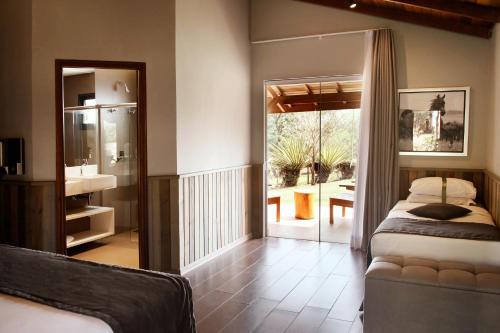 a bedroom with a bed and a view of a patio at Santa Clara Eco Resort in Dourado