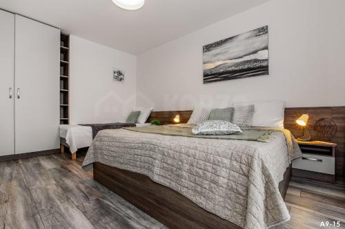 a bedroom with a large bed in a room at KORZO LIPNO 2 in Lipno nad Vltavou