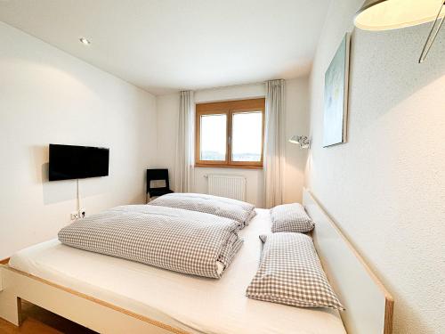 Un pat sau paturi într-o cameră la Chalet Oberstaufen