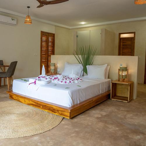 a bedroom with a large bed with flowers on it at Safari Residence Lake Manyara in Mto wa Mbu