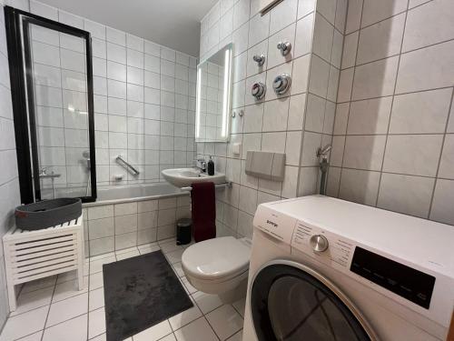 a white bathroom with a washing machine in it at Wohnperle*WindbergBlick*ruhig in Wilsdruff