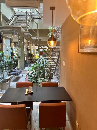a dining room with a black table and chairs at Hotel Everest in Cordoba