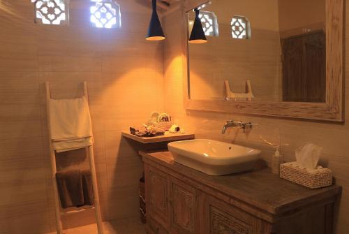 a bathroom with a sink and a mirror at Dhauteya Villa in Ambat