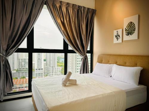 a bedroom with a bed with a large window at New 2BR or 3BR Cozy Urban Suite Homestay at Georgetown8-10pax by URBAN STAYCATIONS LOD in Jelutong