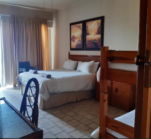 a bedroom with a large bed and a large window at Seabrook holiday apartments in Margate