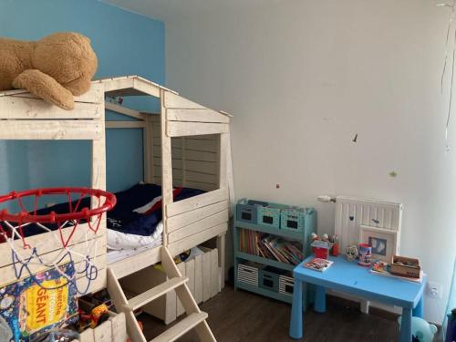 a bedroom with two bunk beds and a desk at Maison proche de Versailles JO2024 in Saint-Cyr-lʼÉcole