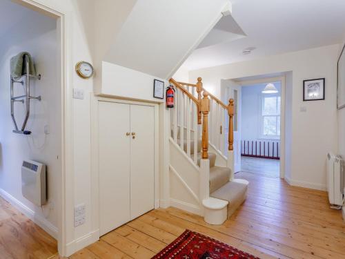 a hallway with white walls and stairs in a home at 3 bed in Achnasheen CA120 in Inveralligin