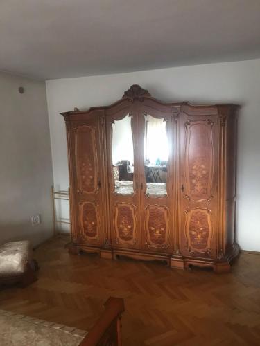 a large wooden cabinet with windows in a room at Vila Ana Ipatescu in Craiova