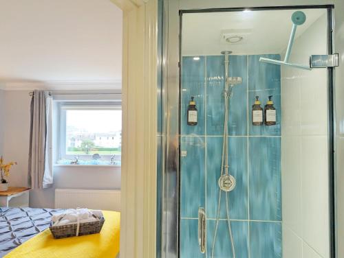 a shower with a glass door in a bedroom at The Gables in Bognor Regis
