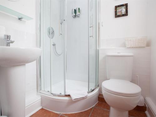 a bathroom with a shower and a toilet and a sink at 2 Bed in Howden G0113 in Saltmarshe