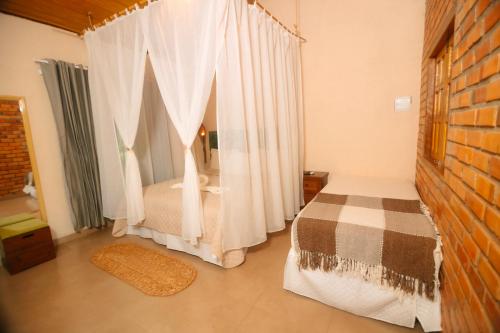 a bedroom with a bed and curtains in a room at Rancho das Estrelas in Carolina