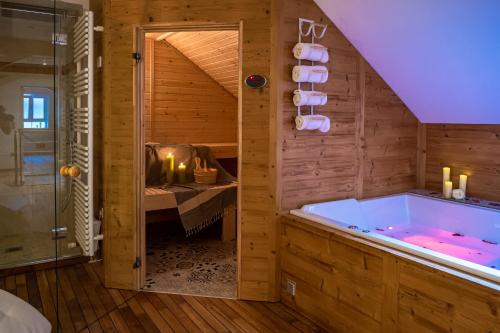 a bathroom with a large tub in a room at La Couronne à Wissembourg in Wissembourg