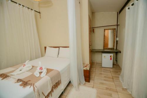 a bedroom with a bed with two stuffed animals on it at Rancho das Estrelas in Carolina