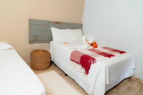 a bedroom with a bed with a stuffed animal on it at Rancho das Estrelas in Carolina
