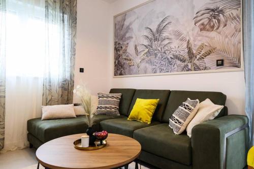a living room with a green couch and a table at Grgic Apartments - Lux APT2 - Free Parking in Zagreb