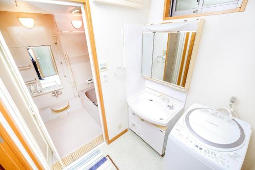 a small bathroom with a sink and a toilet at BBQ!最大14人!駅から5分&有馬温泉直達!長田 in Kobe