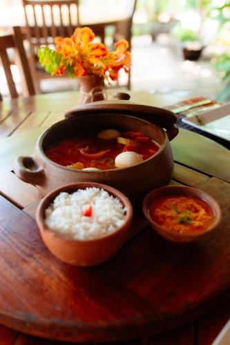 a pot of soup and bowls of rice on a table at Rancho das Estrelas in Carolina