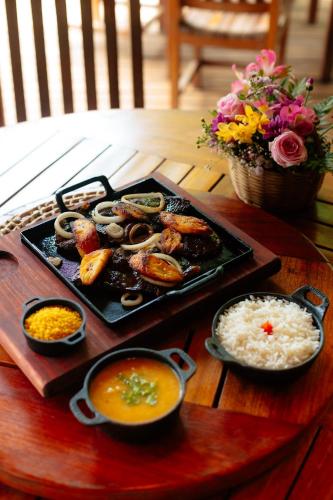 a tray of food on a table with rice at Rancho das Estrelas in Carolina