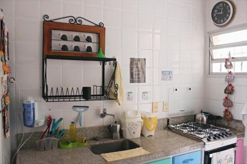 a kitchen with a sink and a stove at Casa Monjardim in Vitória