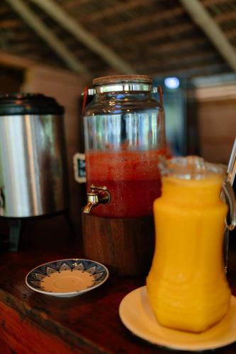 a jar of jam and a plate of juice on a table at Rancho das Estrelas in Carolina