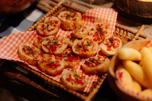 a tray of mini pizzas with cheese and herbs at Rancho das Estrelas in Carolina