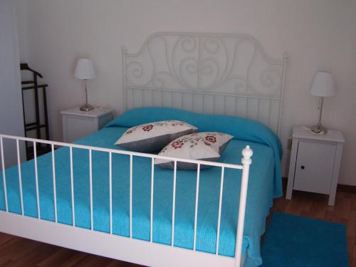 Un pat sau paturi într-o cameră la Appartamenti Condominio Daniele
