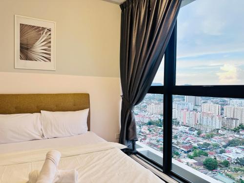 a bedroom with a bed and a large window at New 2BR or 3BR Cozy Urban Suite Homestay at Georgetown8-10pax by URBAN STAYCATIONS LOD in Jelutong