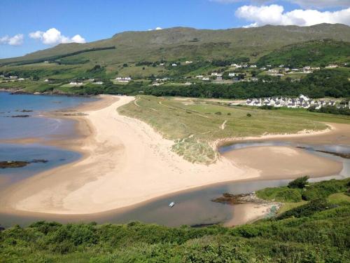 an aerial view of a beach with houses and mountains at An Uaimh , superb 6 bedroom house. in Killybegs
